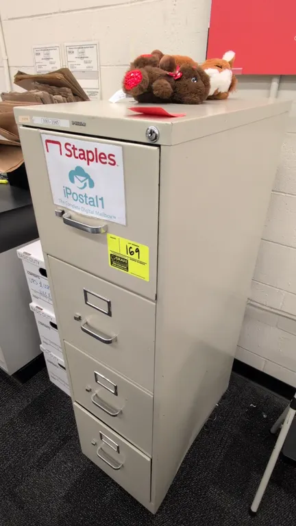 HON 4-drawer vertical filing cabinet. Features metal construction, pull handles with thumb latches, and integrated label holders. 15"W x 52"H. Content