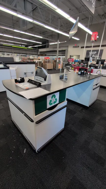Laminate commercial service counter. Features a black laminate countertop with rounded end, (2) integrated under-counter waste and recycling bin cabin