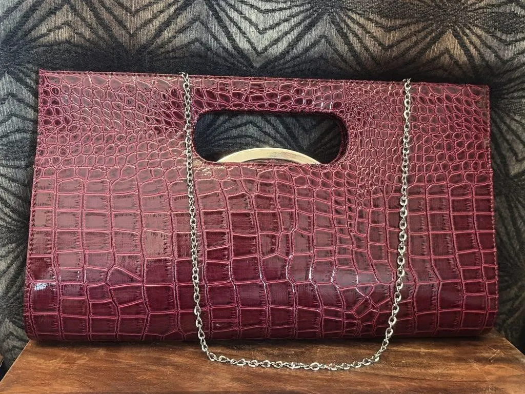 Burgundy crocodile-embossed clutch bag