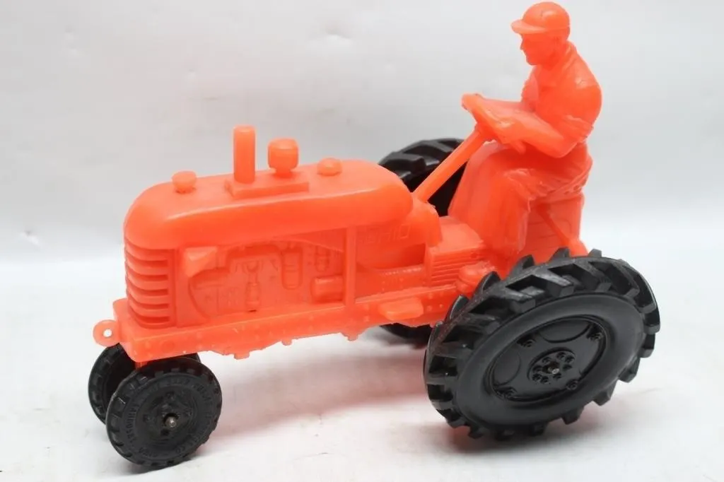 Orange plastic toy tractor with driver figure