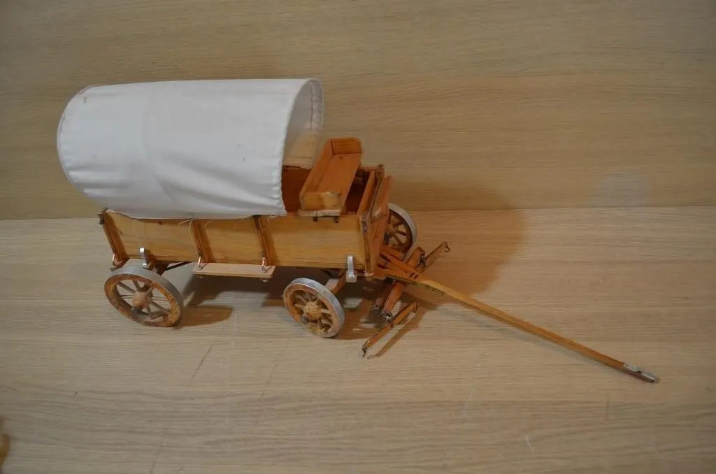 Handmade wooden model of a covered wagon