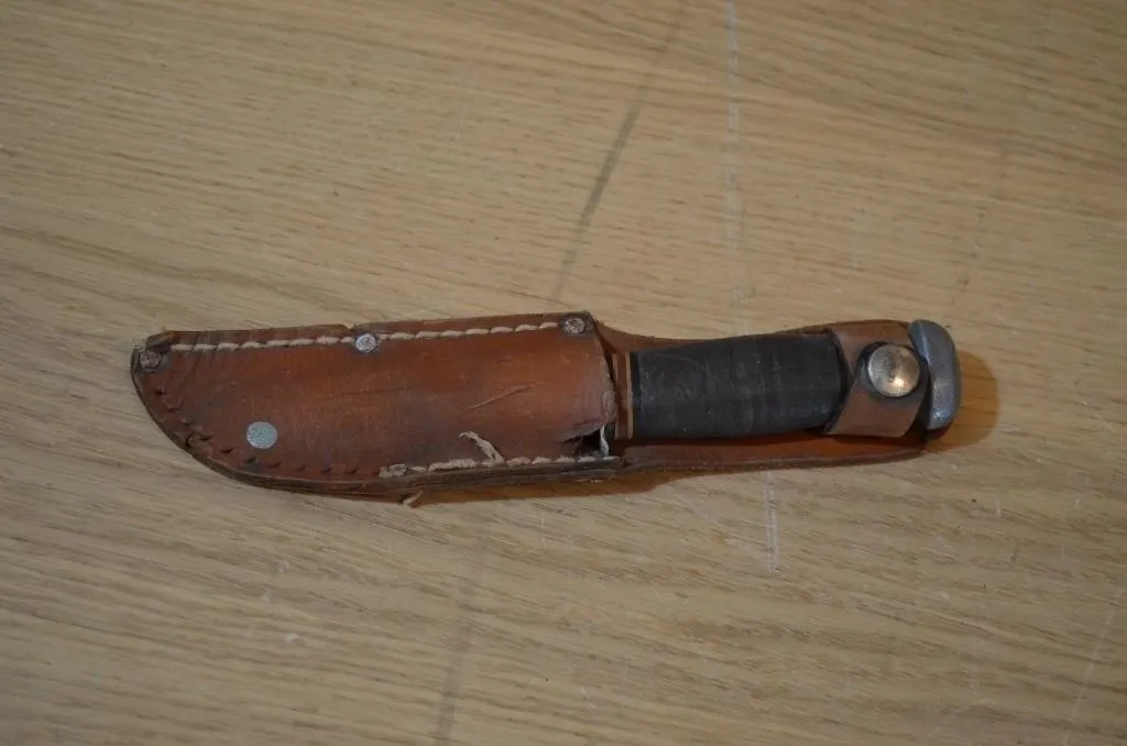 Vintage fixed-blade utility or combat knife housed