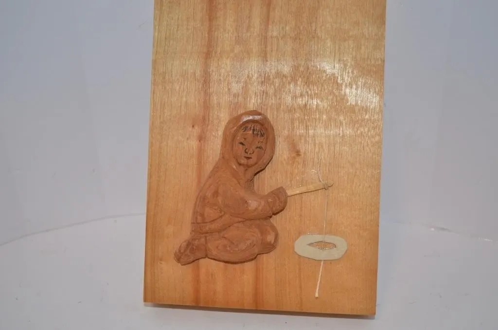 Hand-carved wooden wall plaque featuring a relief