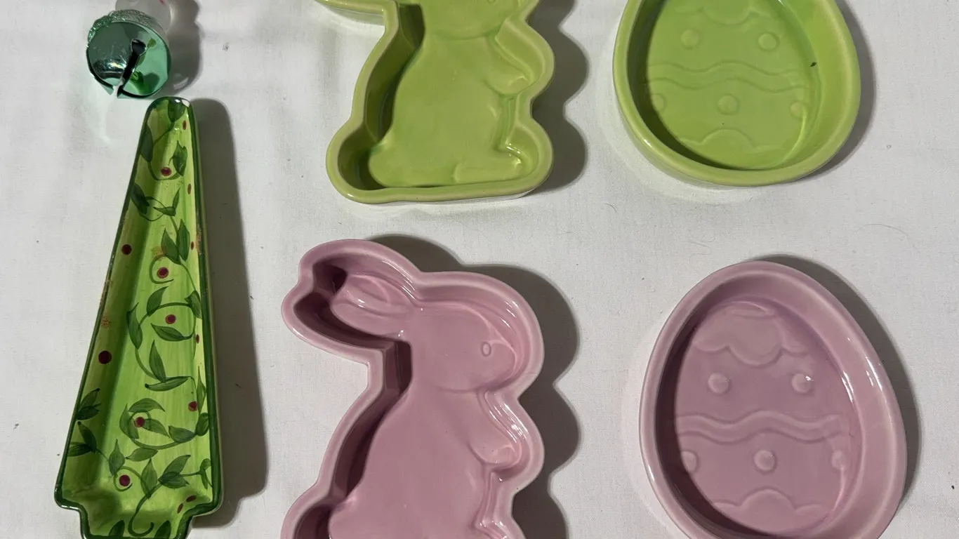 Pair of green and pink rabbit and egg baking dishes with a glass decorative rabbit ornament