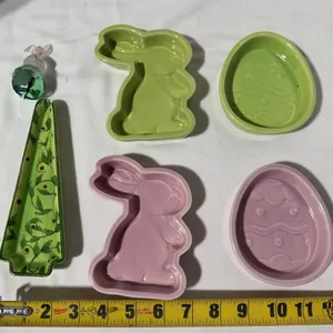 Pair of green and pink rabbit and egg baking dishes with a glass decorative rabbit ornament