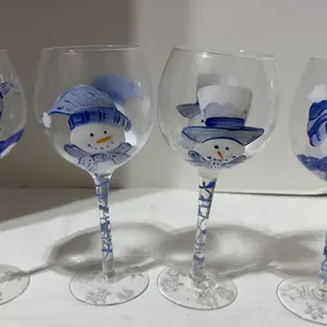 Set of four glass wine goblets featuring festive, hand-painted blue and white snowman designs
