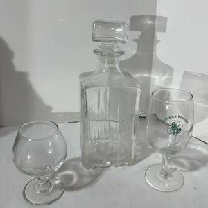 Lot of three vintage items. A whiskey decanter a Jim Beam glass and a shamrock vineyard wine glass.