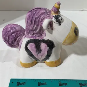 Hand-painted ceramic bank shaped like a unicorn with purple mane and horn