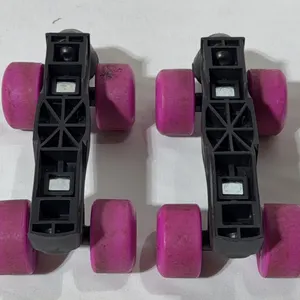 Pair of attachable strap-on heel roller skate frames with black plastic bases and pink wheels