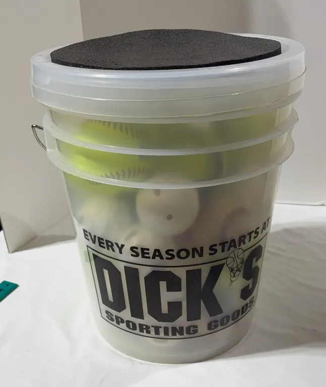 Large bucket of softballs baseballs, and wiffle balls