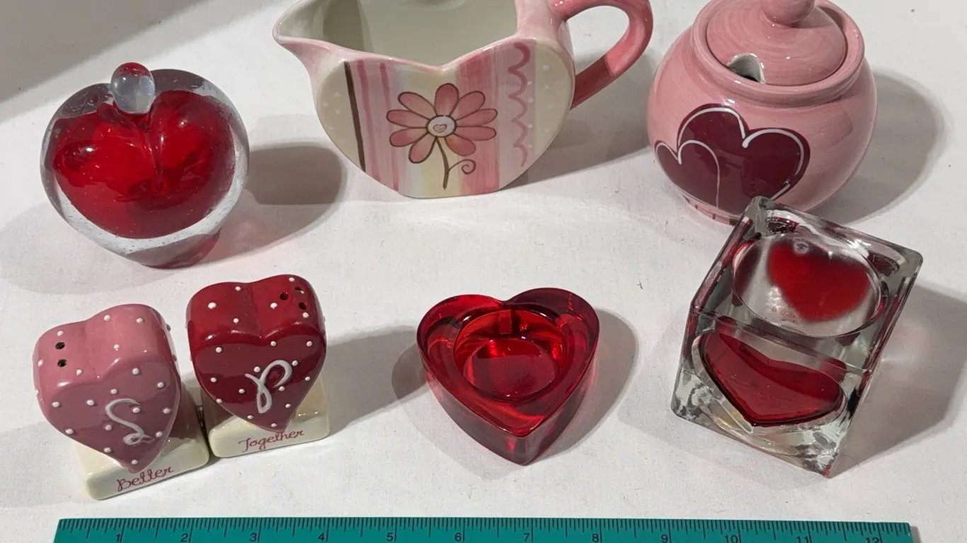 Collection of decorative heart-themed ceramic and glass items
