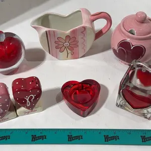 Collection of decorative heart-themed ceramic and glass items