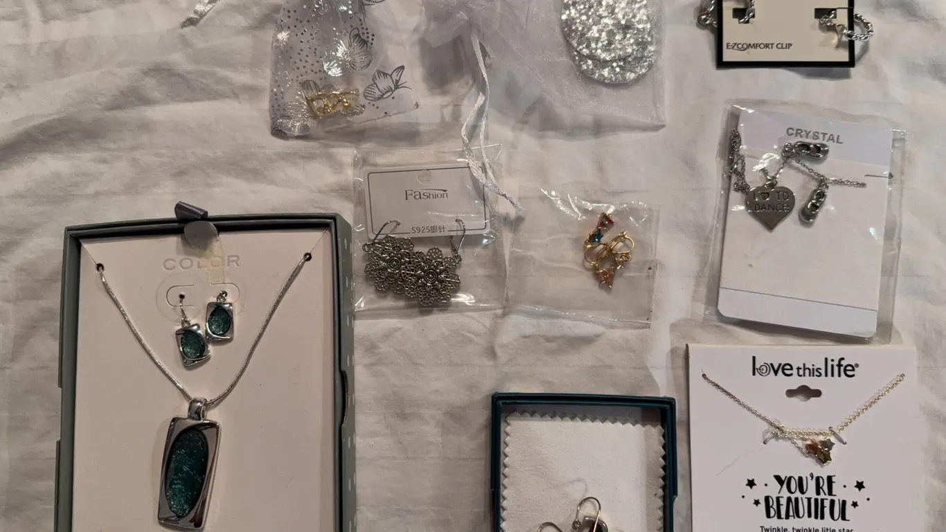 Assortment of fashion jewelry pieces, including boxed necklace sets and earrings