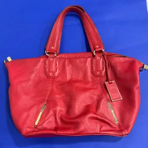 Red Leather Tote Bag Featuring Gold-Tone Hardware and Interior Compartments