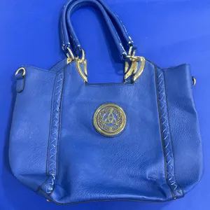 Blue Handbag With Gold Accents and Emblem