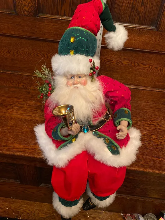 Santa Figurine in Festive Red and Green Outfit Holding a Horn