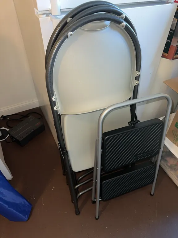 Four folding chairs and folding stepstool