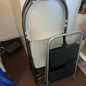 Four folding chairs and folding stepstool