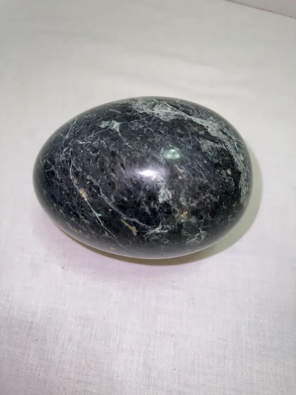Large green marble egg with flecks