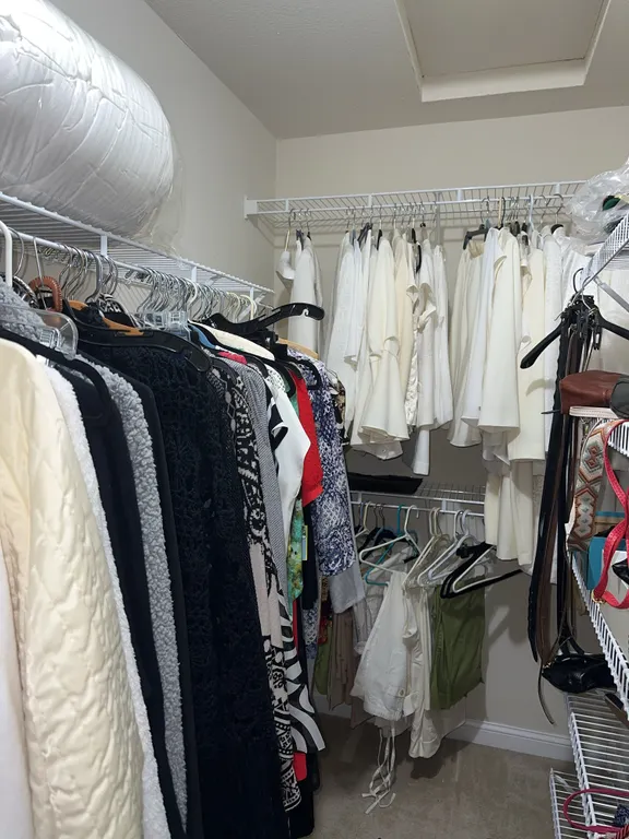 Ladies clothes closet- right – Coach purse, clothing, etc.