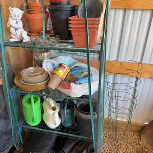 Greenhouse With Planters and Watering Cans