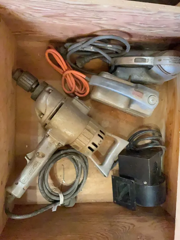 Four Electric Power Tools Including Drill, Two Sanders, and Blower