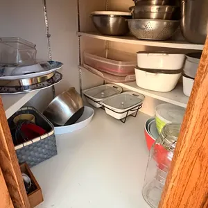 Contents of Corner Cupboard Including Trays, Mixing Bowls and More
