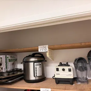 Contents of Closet Shelf Including Broiler Pan, Muffin Tines, Pressure Cooker and Vitamix