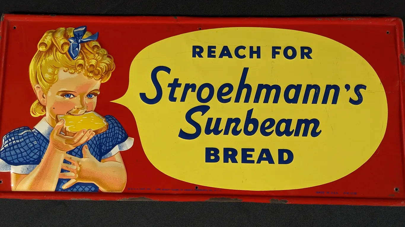 EMBOSSED TIN SIGN REACH FOR STROEHMANN'S SUNBEAM BREAD