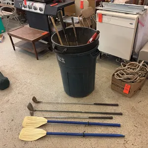 Trash Cans w/ Golf Clubs & Paddles