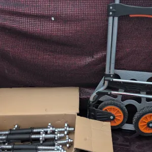 Kubota Folding Hand Truck with Orange Wheels and Box of Dumbbell Bars