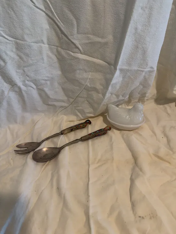 Decorative silverware and nesting chicken 