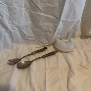 Decorative silverware and nesting chicken ￼
