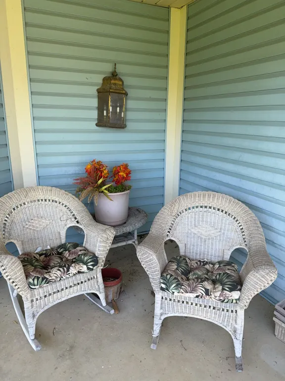 Wicker lawn furniture, two chairs, and a table
