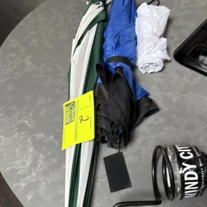 Assorted umbrellas. Lot includes (1) green and white full-size umbrella with wooden handle, (1) blue and black umbrella with straight grip handle, and