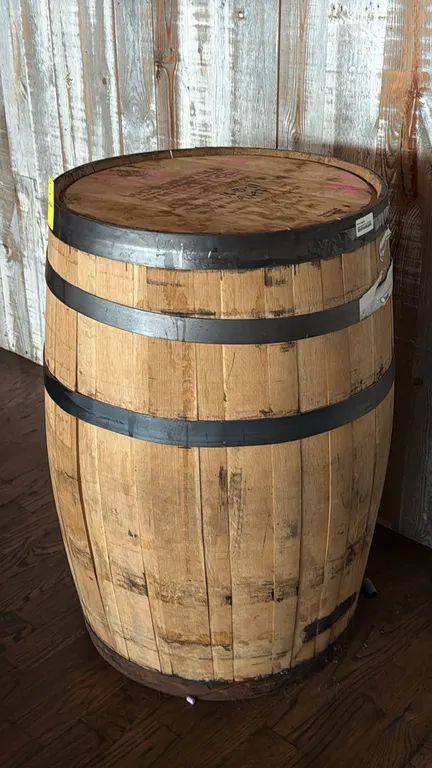 Woodinville Whiskey Co. American oak bourbon whiskey barrel. Features steel hoops, wooden bung plug, and stamped barrel head marked Batch No: 18-B-11,