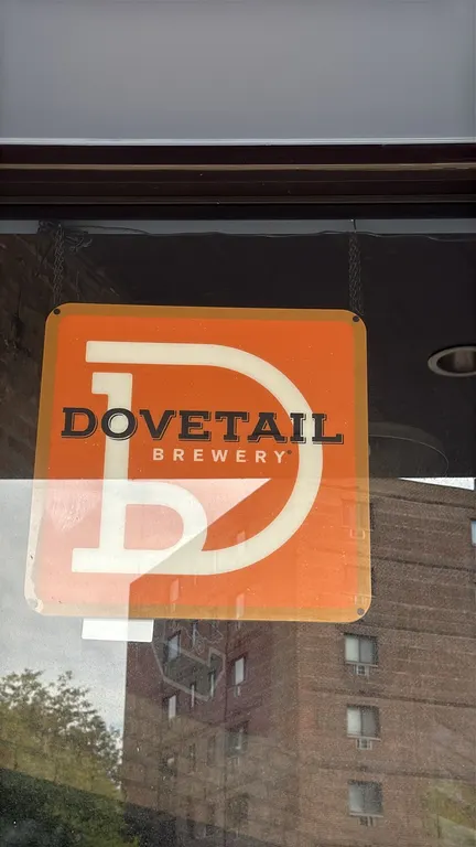 Dovetail Brewery lighted sign. Features orange graphic panel with Dovetail Brewery branding and rounded corners. Includes hanging chain.