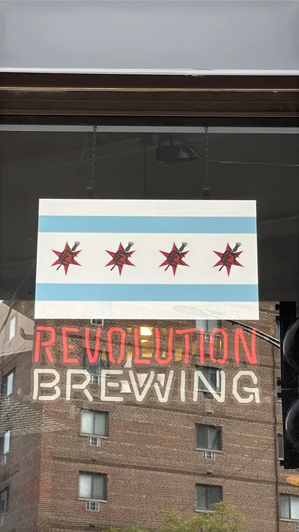 Revolution Brewing illuminated window sign. Features Chicago flag motif panel with Revolution Brewing red star logos, illuminated red 'REVOLUTION' let