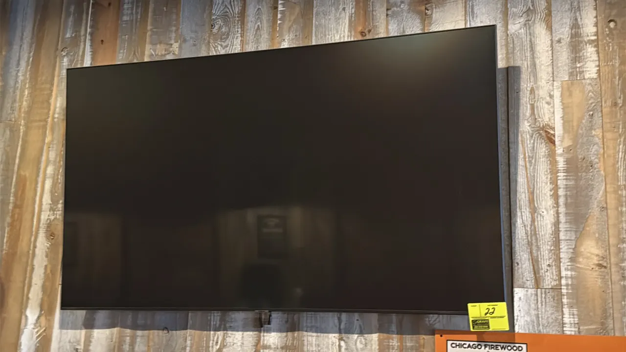 Samsung 65" flat-screen television. Features a slim bezel design. Wall mounted.