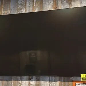 Samsung 65" flat-screen television. Features a slim bezel design. Wall mounted.