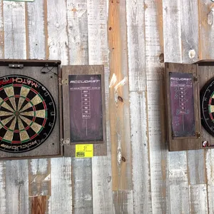 Accudart Match Pro wood dartboard cabinets with dartboards. Features dual hinged doors with integrated cricket scoreboards, sisal dartboards, and over
