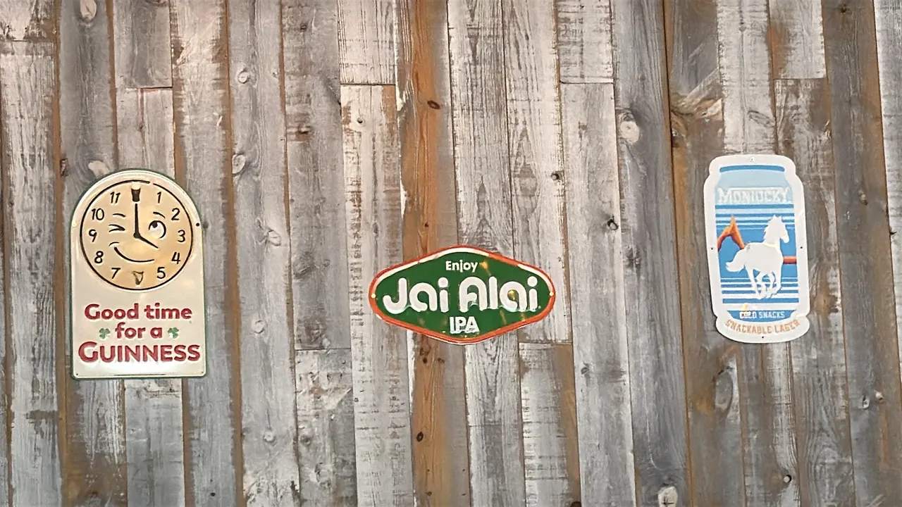 Assorted metal beer advertising signs. Includes Guinness 'Good time for a Guinness' clock-face design sign, 'Enjoy Jai Alai IPA' sign, and Montucky Co