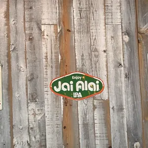 Assorted metal beer advertising signs. Includes Guinness 'Good time for a Guinness' clock-face design sign, 'Enjoy Jai Alai IPA' sign, and Montucky Co