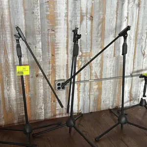 Tripod boom microphone stands. Features adjustable height clutches, adjustable boom arms, and threaded mic mounts. Finished in black. Mounted on foldi
