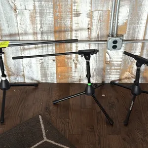JamStands low-profile boom microphone stands. Features adjustable boom arms and collapsible tripod bases with non-slip rubber feet. Finished in black.
