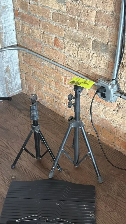 Tripod speaker stands. Features telescoping height adjustment with locking knobs and collapsible folding tripod bases. Finished in black.