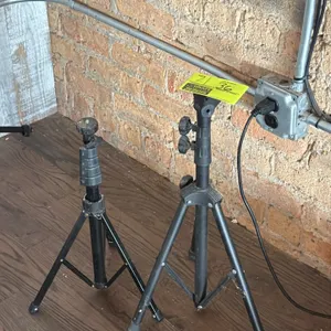 Tripod speaker stands. Features telescoping height adjustment with locking knobs and collapsible folding tripod bases. Finished in black.