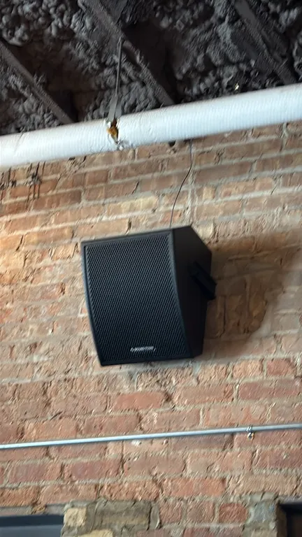 Sound Town commercial speakers. Features black enclosures with perforated grilles, wall-mounting brackets, and ceiling suspension hardware. Includes w