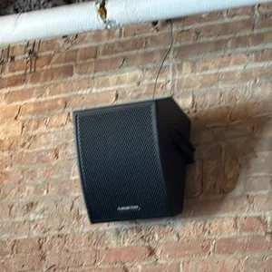 Sound Town commercial speakers. Features black enclosures with perforated grilles, wall-mounting brackets, and ceiling suspension hardware. Includes w