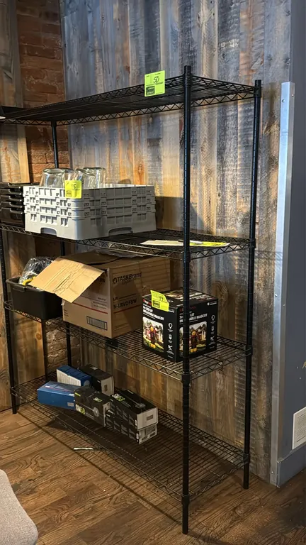 Wire shelving rack. Features (4) adjustable wire shelves and a black finish. 60" x 18" x 72". Mounted on leveling feet. Contents not included.